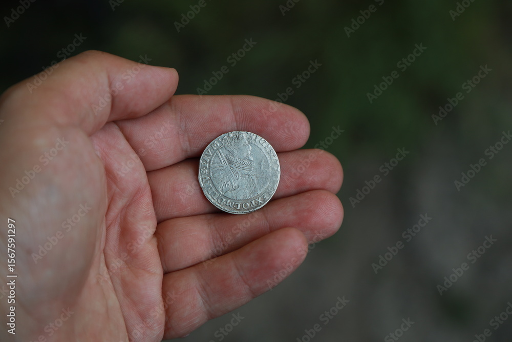 Medieval European silver coin in hand Medieval European silver coin in hand