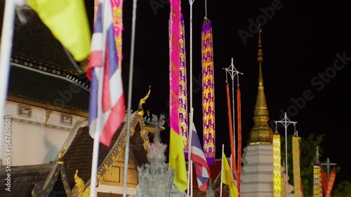 Colorful Lanna and Thai Flags Waving at Chiang Mai Temple � Night Scene