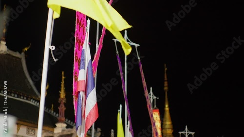 Colorful Lanna and Thai Flags Waving at Chiang Mai Temple � Night Scene