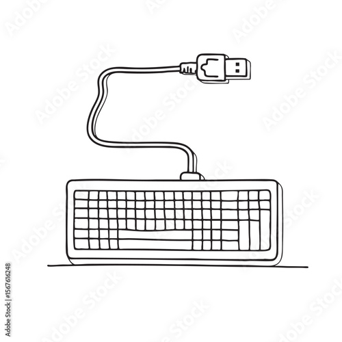 A keyboard connected to a USB cable resting on a worktable