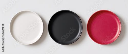Three plates of different colors are shown on a white background