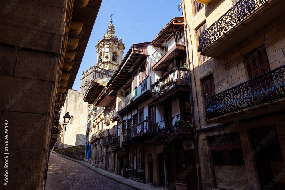 Fototapeta premium Bell Tower of the Church of Santa María de la Asunción, Also Known as Nuestra Señora del Manzano, Seen from Kale Nagusia in Hondarribia