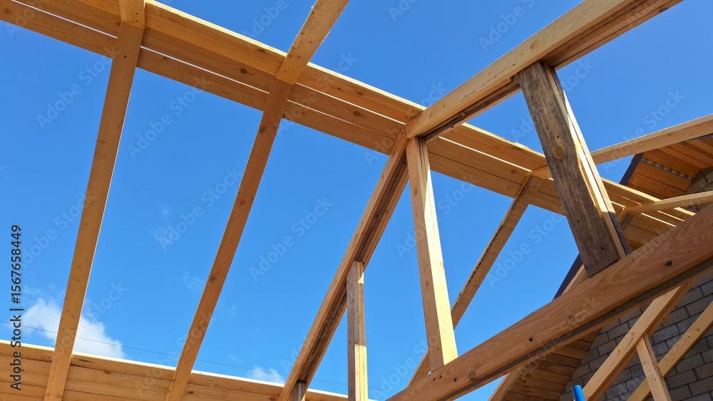 Obraz premium Wooden construction frame against clear blue sky