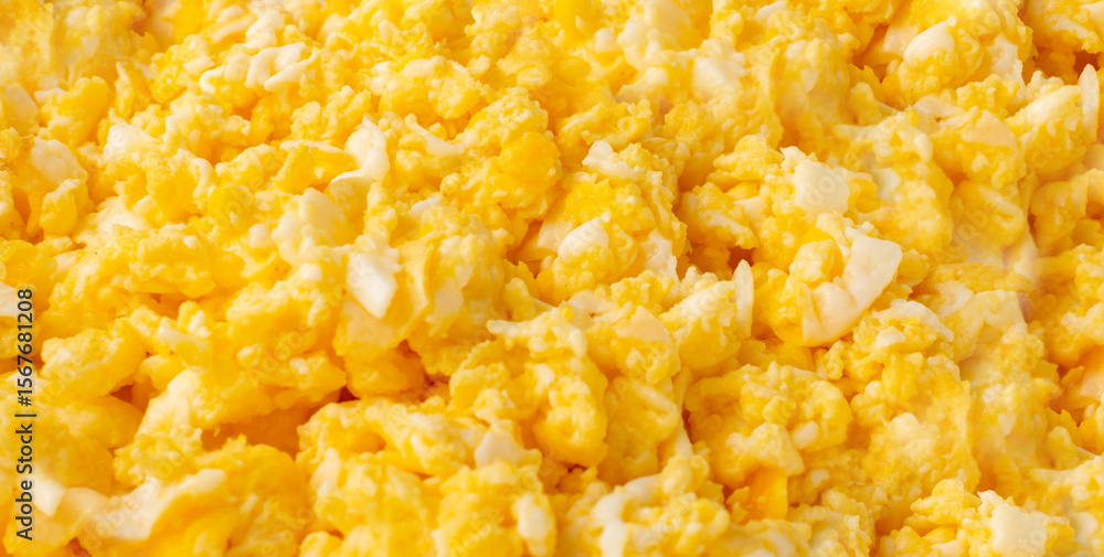Scrambled eggs pattern, omelet wallpaper. Breakfast fried eggs stirred or beaten together Scrambled eggs pattern, omelet wallpaper. Breakfast fried eggs stirred or beaten together