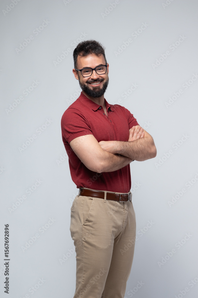 Naklejka premium Smiling Confident Man in Red Polo with Arms Crossed