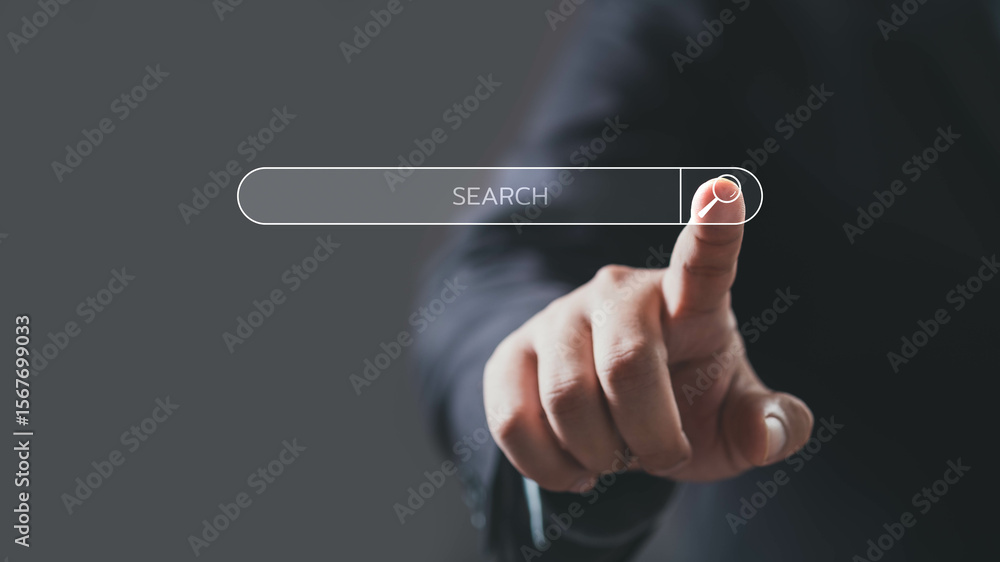 A close-up of a hand pointing at a search bar, symbolizing digital exploration and online searching. A close-up of a hand pointing at a search bar, symbolizing digital exploration and online searching.