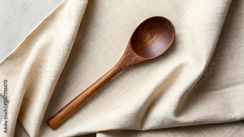 Dark Wood Serving Spoon on Cream Linen Fabric: Rustic, Minimalist Kitchenware Photography