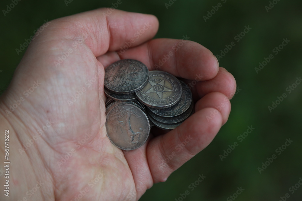 A pile of old Russian silver coins in hand A pile of old Russian silver coins in hand