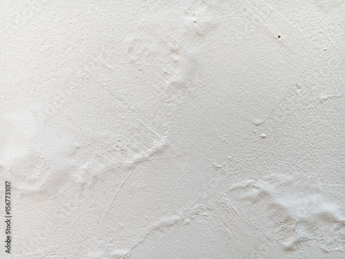 Abstract texture of blistering or bubbles paint on a white wall.	