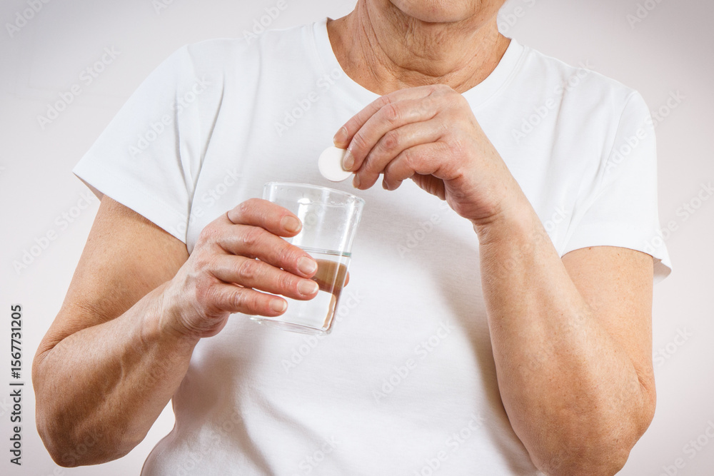 Senior woman with effervescent tablet. Vitamins or supplements. Treatment or strengthening immunity in old age Senior woman with effervescent tablet. Vitamins or supplements. Treatment or strengthening immunity in old age