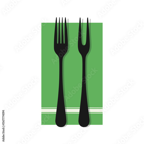 Two forks placed on green napkin with minimalist design for elegant dining experience