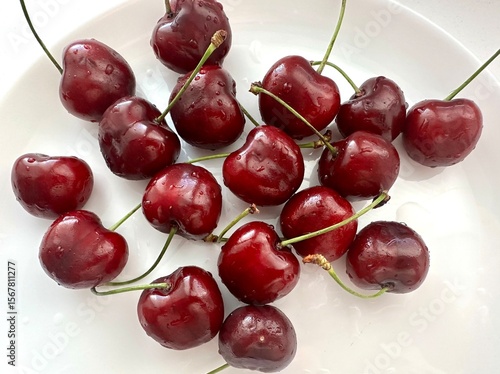 Fresh farm-grown strawberries and cherries on a white background. Organic seasonal berries, handpicked and washed, close-up in natural daylight.