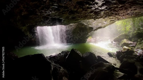 Waterfall Pouring Through Cave Opening – Tropical Rainforest Scene with Rock Arch, Mist, and Lush Surroundings at Natural Bridge, Springbrook National Park, Gold Coast Hinterland
