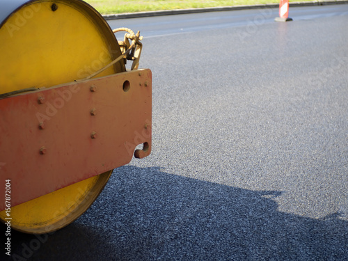 Asphalt paver roller close-...
