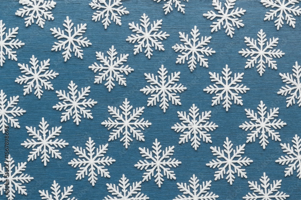 Blue metallic surface adorned with white snowflakes Blue metallic surface adorned with white snowflakes