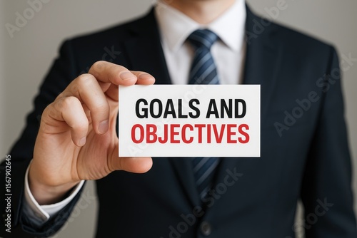 Professional holding a card labeled Goals and Objectives