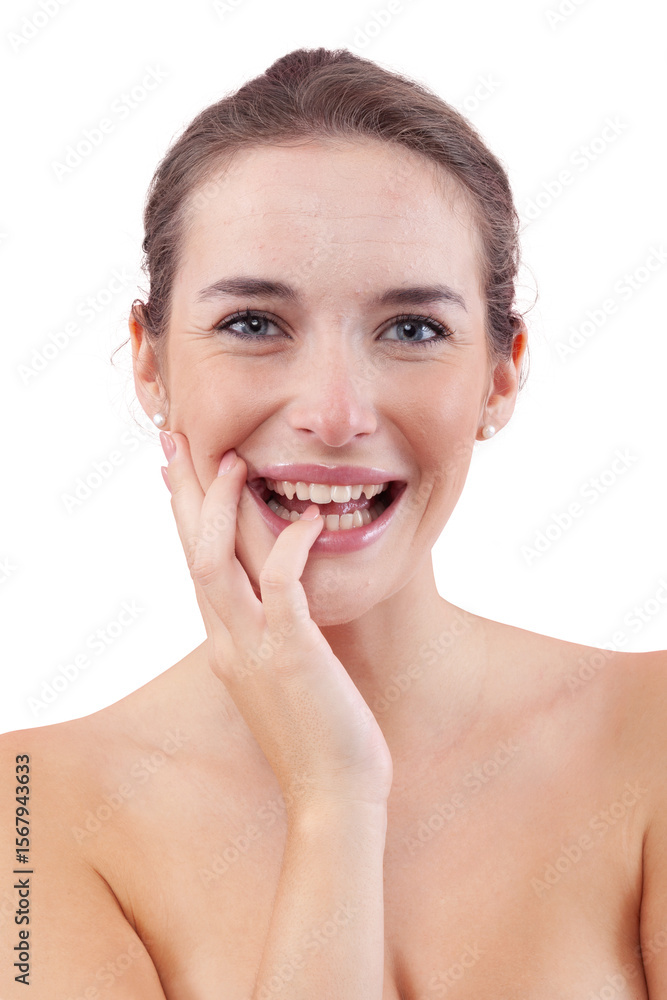 Obraz premium Woman laughing at the camera while touching her face, showing natural skin with facial imperfections, acne and pimples. Authentic female portrait before skincare or beauty treatment. Isolated on white