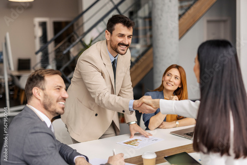 Принти на полотні Happy manager shaking hands with new employee at corporate firm.