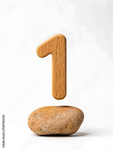 Wooden number one and stone on white background minimalist design simple object natural light studio shot