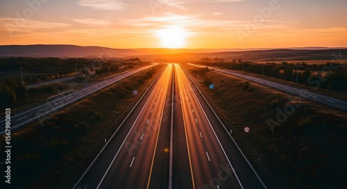 Golden Hour Highway: Sunlit Asphalt and Distant Hills at Sunset