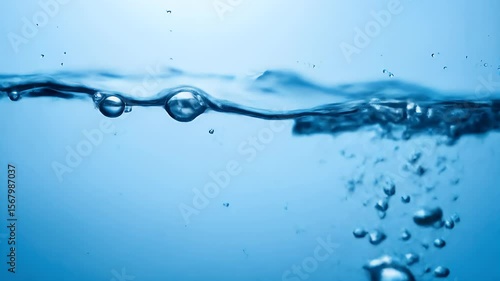Clean Water Bubbles: An underwater macro view of the water line. Fresh air bubbles rise through the clear blue liquid, creating a refreshing and pure abstract background.