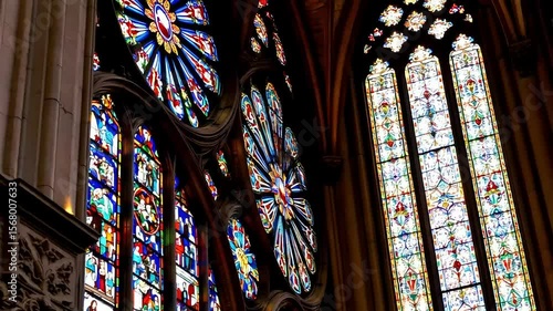 A close up of the stained glass windows of the Cathedral of Chartres, capturing the vibrant colors and delicate designs