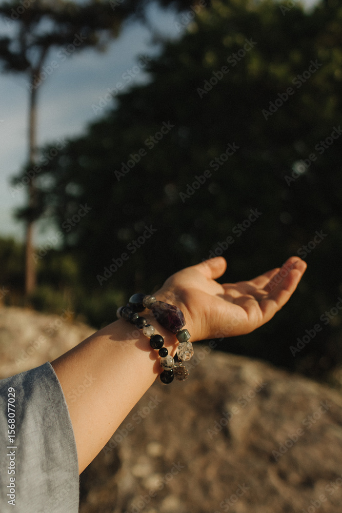 Fototapeta premium Close-up of female hands holding natural healing stones. Tools for energy balance, emotional support, self-discovery through intention, intuition, gentle presence. Vintage tone. Soft focus, blurred