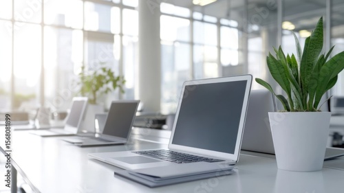 Wallpaper Mural Modern office workspace with sleek desks, laptops and digital screens Torontodigital.ca