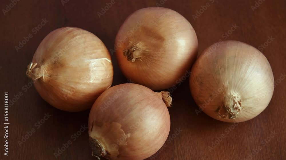Fresh onions on a wooden table. Gourmet cooking and food preparation concept. Fresh onions on a wooden table. Gourmet cooking and food preparation concept.