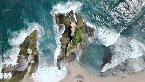 Ocean waves flowing over the rocks on the beach.