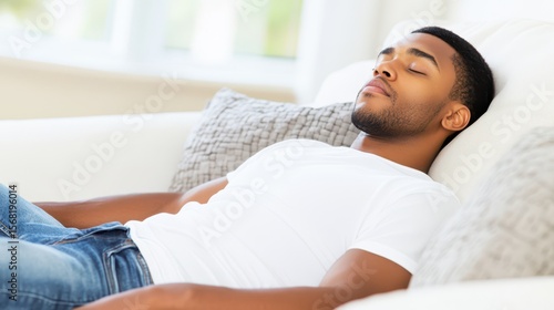 Restful Slumber: A portrait of serenity, featuring a young man lost in tranquil sleep on a comfortable sofa, embodying peace and relaxation.