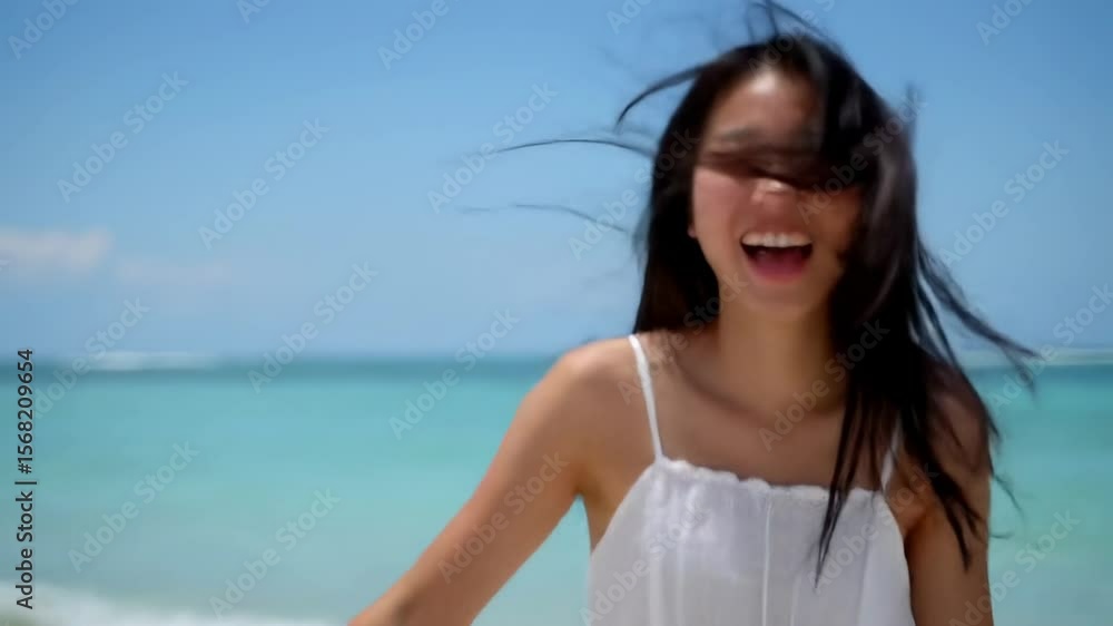 Young woman laughing on beach Young woman laughing on beach