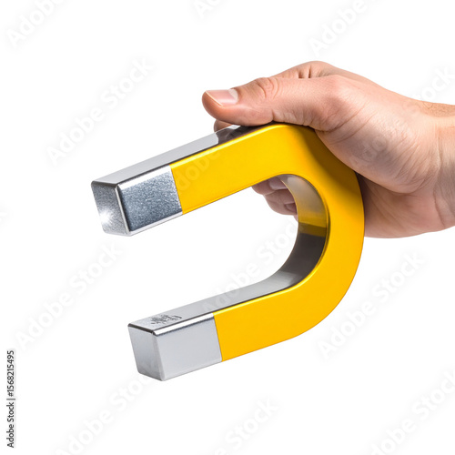 Hand holding yellow horseshoe magnet against black background
