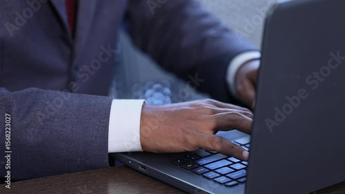 Closeup of college student working with laptop taking notes inside the classroom.education concept