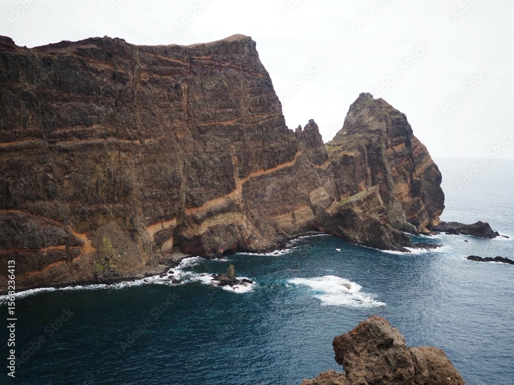 Fototapeta premium Desert landscapes of Cape Sao Lourenco. Volcanic cliffs rising above the ocean. Nature of Madeira Island, Portugal, PR8 Vereda da Ponta de Sao Lourenco.