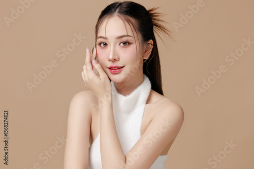 Beautiful portrait Asian Thai woman makeup of cosmetic on face smile attractive isolated on beige background.