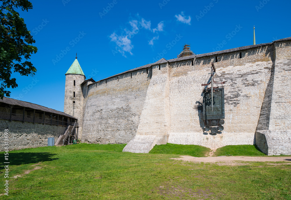 Fototapeta premium A view of the Pskov Kremlin fortress wall by Percy and Installation with a sword in honor of the victory over the Livonians in the Battle of the Icei, Pskov, Russia.