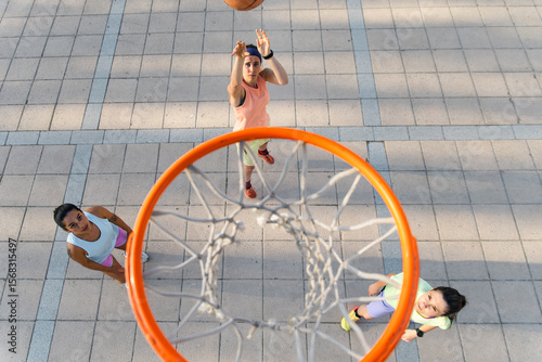 Women playing street basketball in high spirits