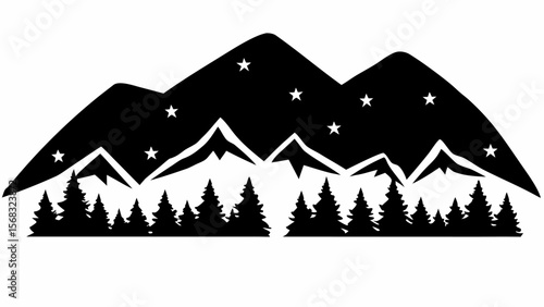 Silhouette of mountains with stars above and a forest of trees in the foreground at night time scene