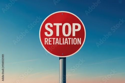 Red Round Stop Retaliation Sign with White Text on Pole Under Blue Sky