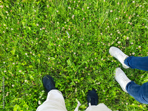 Male and female POV walking on the grass in a park,field, nature walk, physical activity.