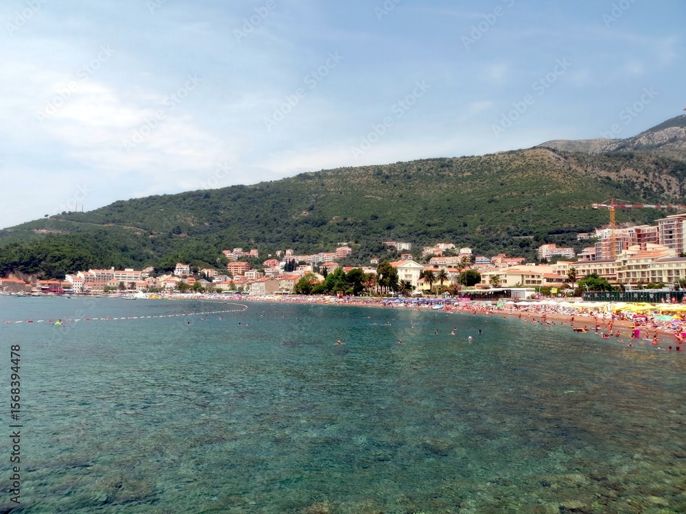 Fototapeta premium Relaxing Beach Day in Petrovac, Montenegro With Clear Waters and Vibrant Summer Activities