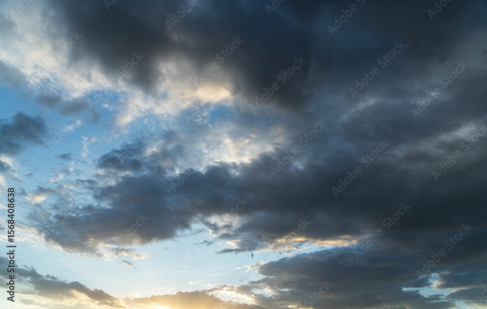 Fototapeta premium Beautiful bright sunset sky background with clouds. Evening time.