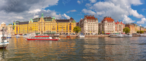Photography Boats moored along Strandvagen waterfront with historic building in Stockholm, S