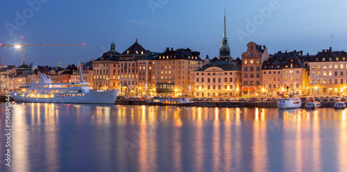 Photography Panoramic view of Gamla Stan waterfront with boats at sunset in Stockholm, Swede