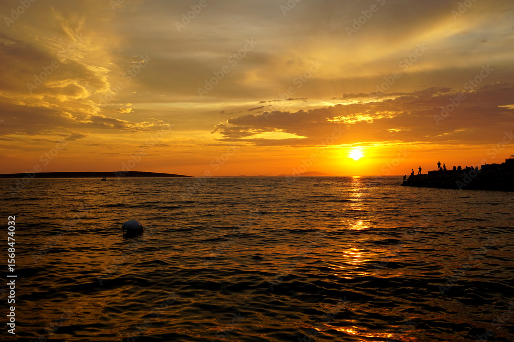 Obraz premium Summer sunset scenery on the seacoast in orange and brown color tone