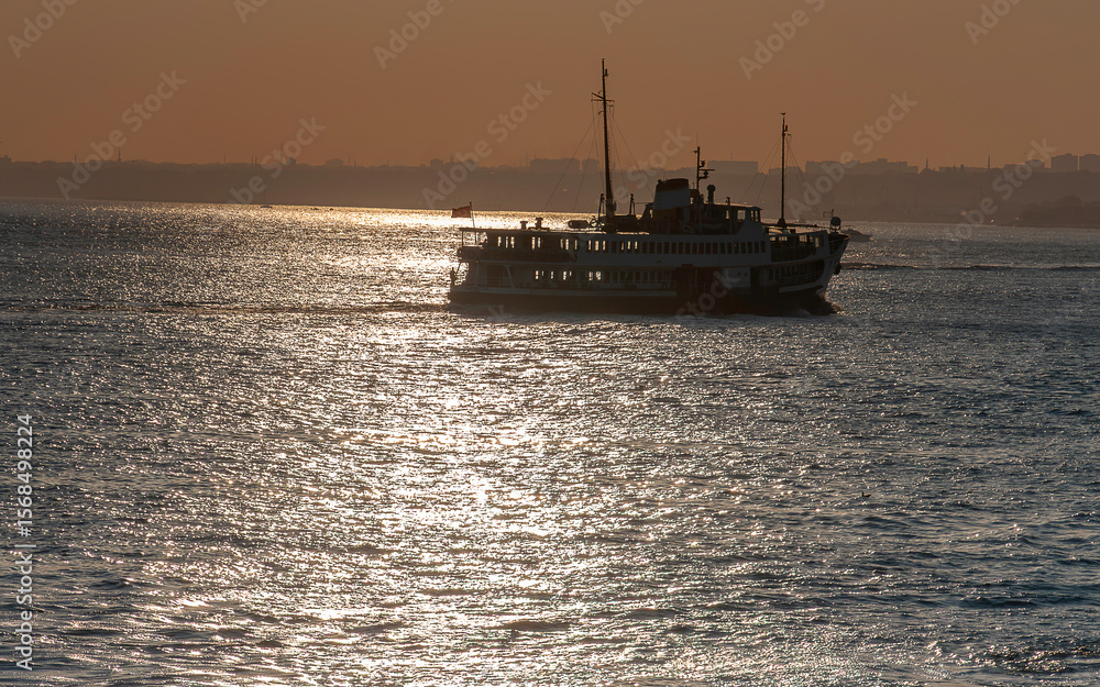 Fototapeta premium Transportation from one side of Istanbul to the other by ship at sunset