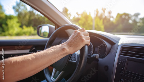 Wallpaper Mural Male Hand Holding Steering Wheel While Driving a Car on a Bright Sunny Day with Trees in View Torontodigital.ca