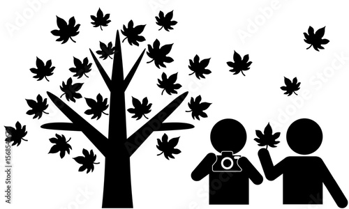 紅葉を楽しむ二人の人物と秋の木のピクトグラム