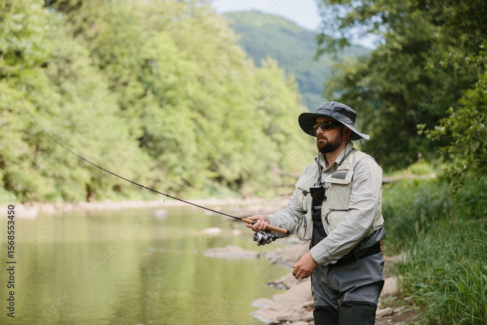 Fisherman casting line in river, enjoying trout fishing in nature Fisherman casting line in river, enjoying trout fishing in nature